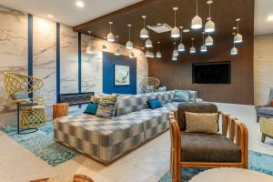 a living room with a couch and a chair at Cambria Hotel Ocean City - Bayfront in Ocean City