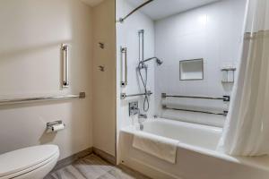 a bathroom with a toilet, bathtub, and shower stall at Cambria Hotel Ocean City - Bayfront in Ocean City