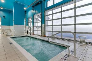 a swimming pool with a tub and a bathtub in it at Cambria Hotel Ocean City - Bayfront in Ocean City