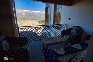 a balcony with chairs and a view of the mountains at Hotel Praga in Gjirokastër