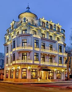 a large white building on the corner of a street at Royal Hotel in Varna City