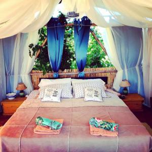 a bedroom with a bed with blue and white curtains at Al Aire Libre in San Rafael