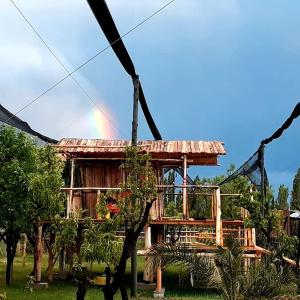 a wooden house with a rainbow in the background at Al Aire Libre in San Rafael