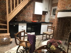 a kitchen with a counter and a table and chairs at Chateau de Vauchelles in Vauchelles-lès-Domart