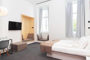 a hotel room with a bed and a table and chairs at Maverick Budapest Soho in Budapest