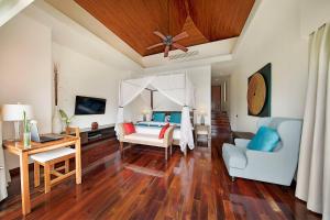 - une chambre avec un lit, un canapé et une table dans l'établissement Dhevatara Cove, à Lipa Noi