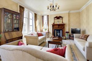 a living room with couches and a fireplace at The Edwardene in Keswick