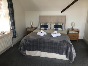 a bedroom with a bed with two towels on it at Southover Beach in Woolacombe