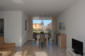 a living room with a table and a dining room at Golf Mar II A 1-4 in Pals