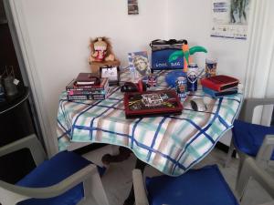 a table with books and other items on it at Apollon Apartments H-3 H-4 in Rhodes Town