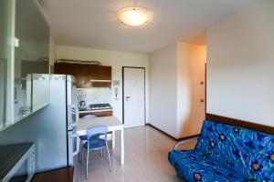 a living room with a couch and a kitchen at Torcello in Bibione +24 photos