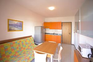 a kitchen with a couch and a table in a room at Ducale in Bibione