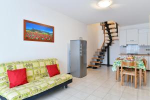 a living room with a couch and a table at Villaggio Luna Due in Caorle