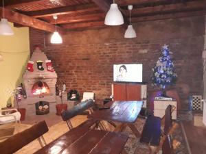 a living room with a christmas tree and a fireplace at Pensiunea Leia in Cîrţişoara
