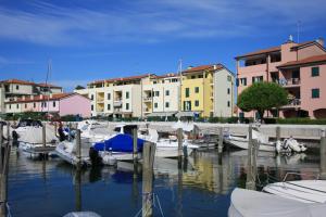 a group of boats docked at a marina with buildings at Albatros in Caorle