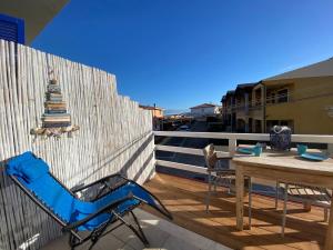 a blue chair and a table on a balcony at Il Faro La Ciaccia in Codaruina