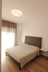 a bedroom with a large bed and a large window at Belo Horizonte in Civitanova Marche