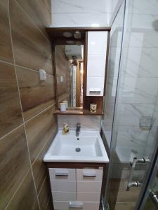 a bathroom with a sink and a mirror at Jahorina 7Lux in Jahorina +48 photos