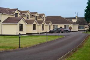 a house with cars parked on the side of a road at Hillview House in Lusk