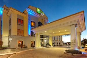 a hotel with a sign on the front of it at Holiday Inn Express Trincity by IHG in Piarco