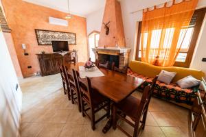 a living room with a dining room table and a couch at Casa Diana P3115 in Riola Sardo