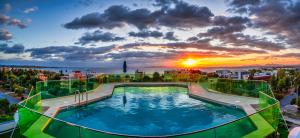 a large swimming pool in a city with a sky background at Emmantina Hotel in Athens
