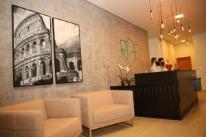 una sala de espera con dos sillas y una foto del coliseo en Raf Hotel, en Umuarama