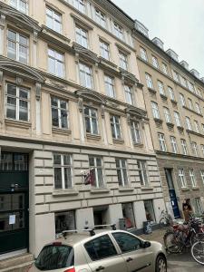a car parked in front of a large building at ApartmentInCopenhagen Apartment 547 in Copenhagen