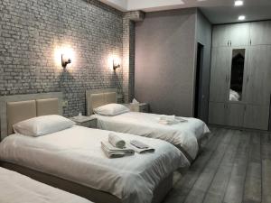 A bed or beds in a room at Flamenco Hotel