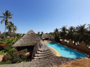 a resort with a swimming pool next to a building at HOTEL MARIA TERESA in Playa Azul