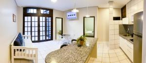 a kitchen with a counter top in a room at Ala Moana Pousada in Bombinhas