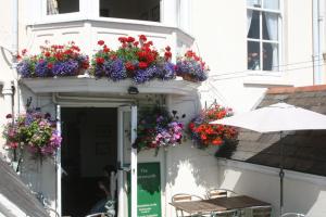 a building with flower boxes on the side of it at The Chatsworth in Weymouth