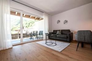 a living room with a couch and a table at Modern Living by Nalserhof in Nalles