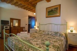 a bedroom with a bed and a television in a room at Arpaderba B&B in Livorno