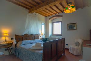 a bedroom with a bed and a table and a lamp at Arpaderba B&B in Livorno
