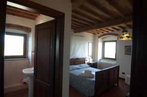 a bedroom with a bed and a bathroom with a sink at Arpaderba B&B in Livorno