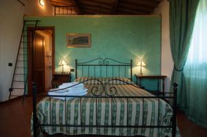 a bedroom with a bed with a green wall at Arpaderba B&B in Livorno