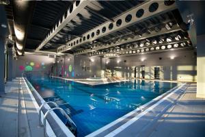 a large swimming pool in a large building at Village Hotel Southampton Eastleigh in Southampton