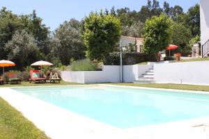 a swimming pool in the yard of a house at Casa nas Serras in Vila Nova de Poiares
