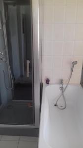 a bathroom with a shower with a hose attached at venez visitez calais in Calais