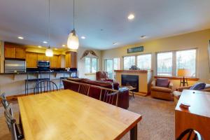 a kitchen and living room with a table and chairs at Beautiful East Vail 3 Bedroom Condo w/Hot Tub On shuttle Route. in Vail
