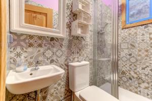 a bathroom with a toilet and a sink and a shower at Factory Suites Barcelona in Barcelona