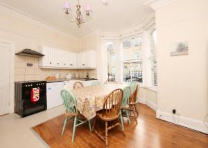 a kitchen and dining room with a table and chairs at Holiday Homes in York in York