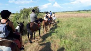 a group of people riding horses on a field at Villa émeraude dans résidence in Cap d'Agde