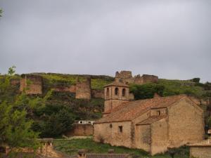 an old building and a castle on a hill at Casa Rural Campoamor in Riópar