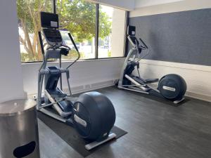 a gym with two elliptical machines in a room at Crowne Plaza Jacksonville Airport, an IHG Hotel in Jacksonville