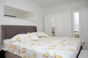 Postel nebo postele na pokoji v ubytování Pearl Apartment
