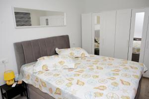Postel nebo postele na pokoji v ubytování Pearl Apartment