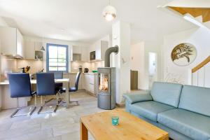 a living room with a couch and a fireplace at Pirateneiche in Glowe