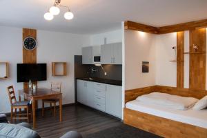 a bedroom with a bed and a table and a kitchen at LuPartment in Ludwigshafen am Rhein